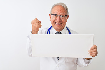 Senior grey-haired doctor man holding banner standing over isolated white background screaming proud and celebrating victory and success very excited, cheering emotion