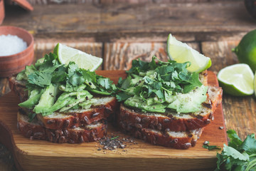 Avocado toasts with cilantro and lime, healthy plant based sandwiches