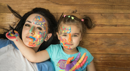 Mother and daughter. Happy family. Bright makeup.