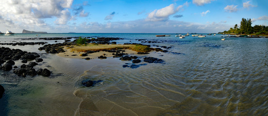 Seascape of Cap Malheureux with small boats in further background, Mauritius.