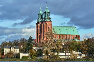 Gothic cathedral church and lake in autumn in Gniezno ... - obrazy, fototapety, plakaty