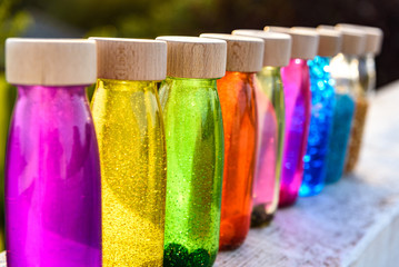 Group of bottles of calm anti stress, therapy to control stress and nerves of alternative education, filled with colored liquids to observe and relax.