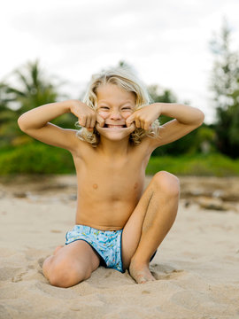 Boy making face on beach