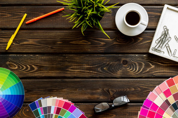Designer office desk with tools, pallet, coffee and glasses on wooden background top view mock up