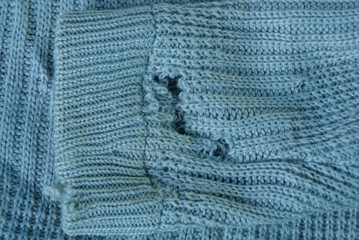 one torn gray wool sleeve on a piece of old clothes