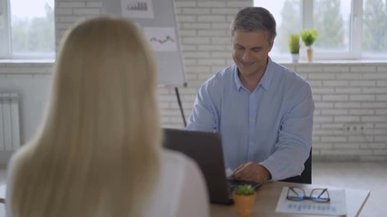 Satisfied business partners, woman client and company manager having positive pleasant talk succeed agreement shaking hands, applicant girl successfully passed job interview handshaking with employer