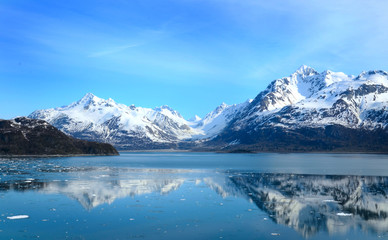 Naklejka na ściany i meble Glacier Bay in Alaska with reflection in the water. mountain landscape with the snow. Iced mountain reflection in the water. Global warming concept. 