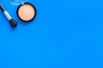 Instruments for make up with brushes, powder on blue background top view mock up