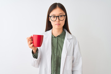 Young chinese dooctor woman wearing glasses drinking coffee over isolated white background with a confident expression on smart face thinking serious