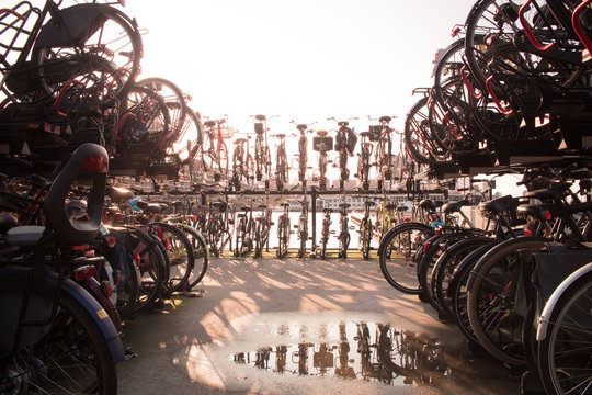 image of bikes in a bike parking with a stunning reflection in the foreground