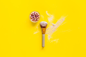 Instruments for make up with brushes, blusher on yellow background top view mock up
