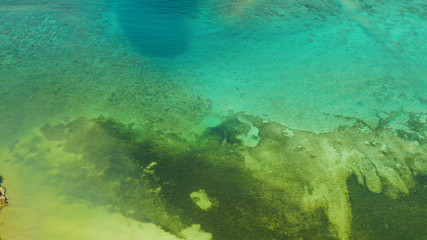 Fototapeta na wymiar Sea water surface in lagoon, copy space for text, aerial view. Top view transparent turquoise ocean water surface. background texture