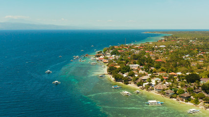 Coral reef and turquoise water with Philippine boats in the famous diving spot of Moalboal, Cebu. Aerial view, Summer and travel vacation concept