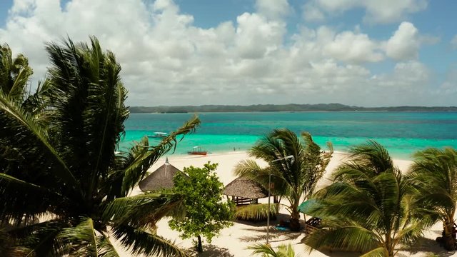 Travel concept: sandy beach on a tropical island by coral reef atoll from above. Daco island, Philippines. Summer and travel vacation concept