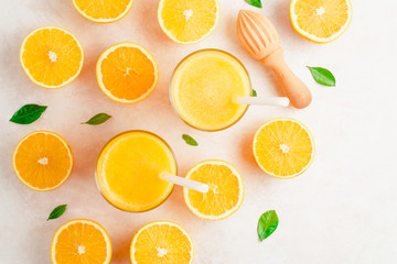 Obraz na płótnie Canvas Fresh Orange juice in glass and fresh citrus around. Healthy drink on white. Top view.