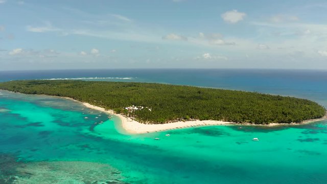 Tropical island with beautiful beach, palm trees and turquoise water view from above. Daco island, Philippines. Summer and travel vacation concept
