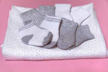 Newborn socks on a pink background collected for baby shower