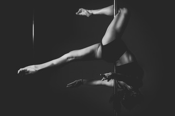 silhouette of pole dancer woman in action. - obrazy, fototapety, plakaty