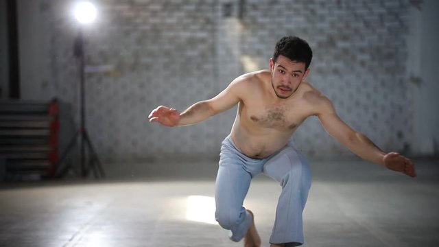 Man crouching and kicking - Showing capoeira elements