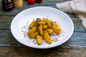 The potatoes wedges on blue wood table