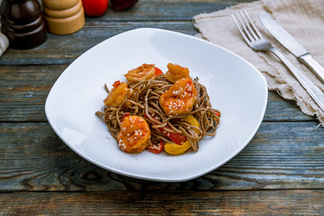 wok with shrimp on blue wood table