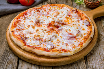 Italian meat pizza on wooden table