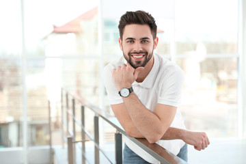 Fototapeta premium Portrait of handsome man smiling in light room