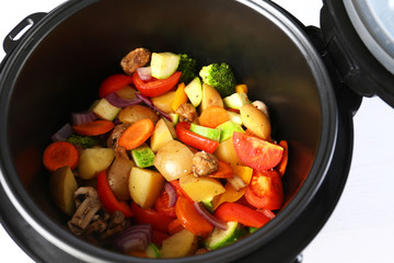 Closeup view of multi cooker with vegetables