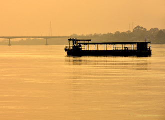 sunset on river,Ferry in the Mekong River at Nong Khai, Thailand