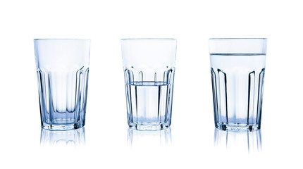 Empty, half and full glasses of water on white background