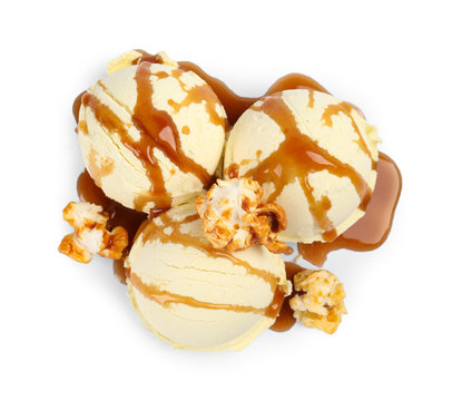 Delicious ice cream with caramel popcorn and sauce on white background, top view