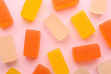 Tasty bright jelly candies on color background, top view