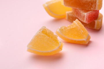 Tasty fresh jelly candies on color background