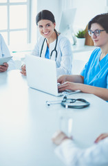 Serious medical team discussing patient's case in a bright office