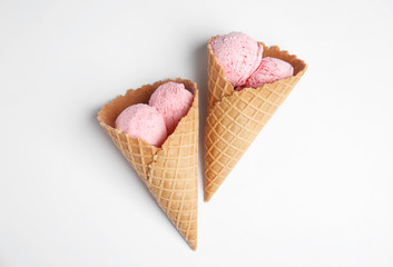 Delicious ice creams in wafer cones on white background, top view