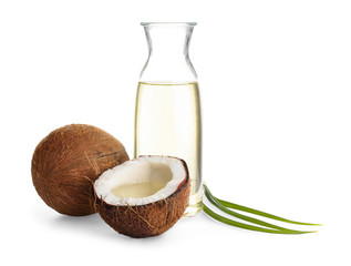 Ripe coconuts and bottle with natural organic oil on white background