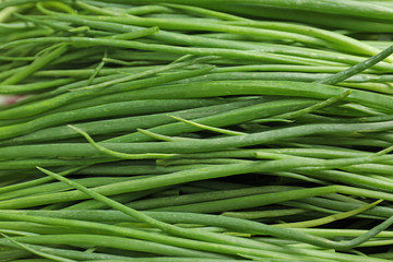Fresh green onions as background, top view