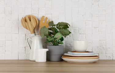 Green plant and different kitchenware on table near brick wall. Modern interior design