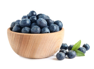 Bowl of fresh raw blueberries with leaves isolated on white