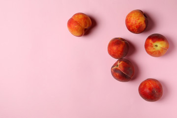 Sweet juicy peaches on pink background, top view. Space for text