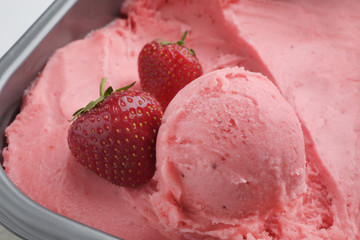 Scoop of delicious strawberry ice cream with fresh berries, closeup