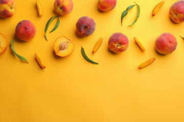 Flat lay composition with fresh peaches on yellow background. Space for text