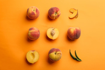 Flat lay composition with fresh peaches on orange background