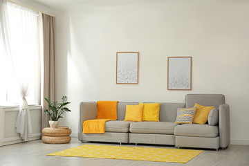 Stylish living room interior with comfortable grey sofa