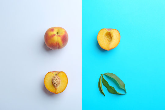 Flat lay composition with fresh peaches on color background