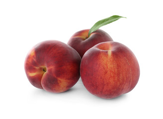 Delicious ripe peaches with leaf isolated on white