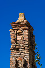 Very old chimney made of red bricks not in use