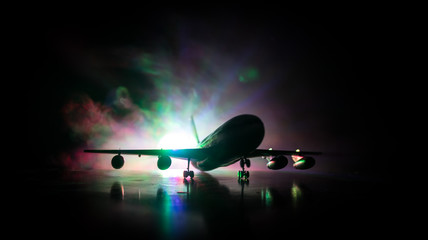Artwork decoration. White passenger plane ready to taking off from airport runway. Silhouette of...