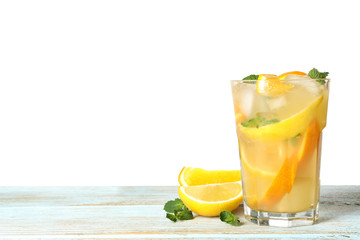 Fototapeta premium Glass of citrus refreshing drink on wooden table against white background