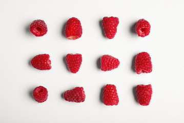 Composition with delicious ripe raspberries on white background, top view